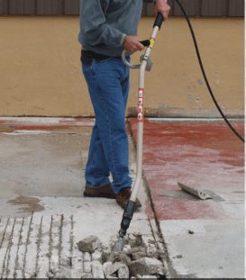 air powered chisel scaler removing coating from concrete surface